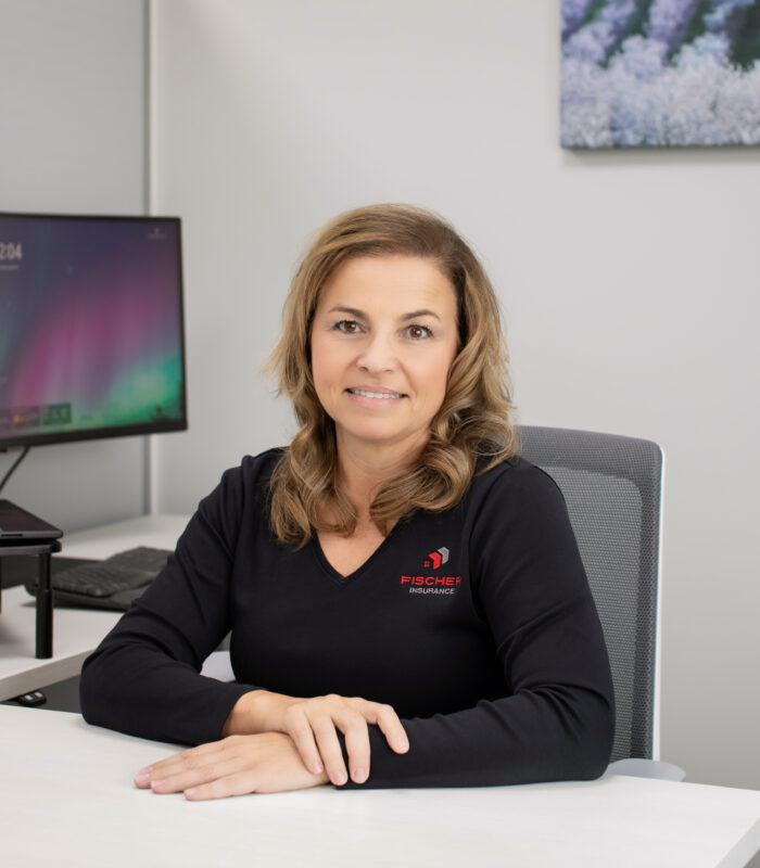 Meet Our Team - Professional and Welcoming Group at a Conference Table Faces the Camera, Team Leader Sitting on the Table with Arms Folded